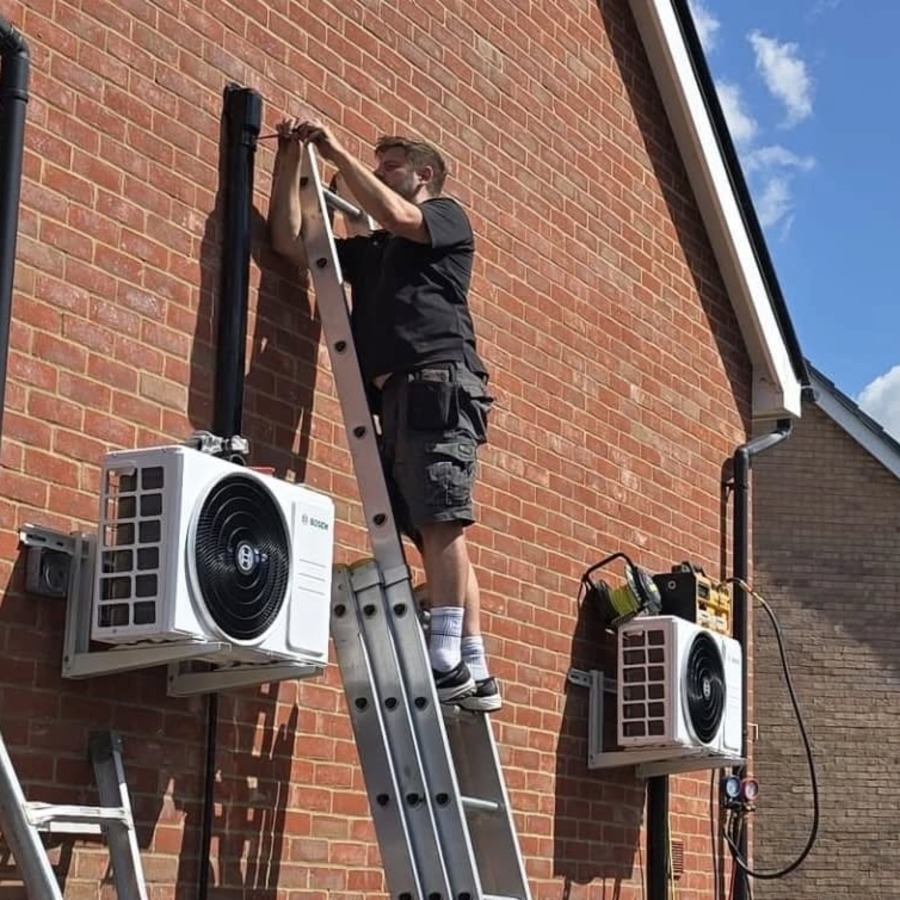 A technician repairing an outdoor air conditioner