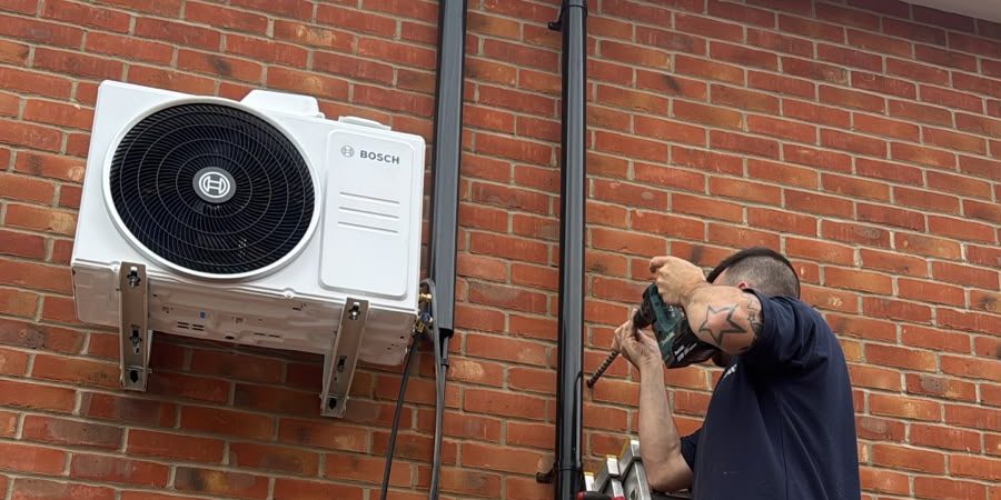 A technician repairing an outdoor air conditioner