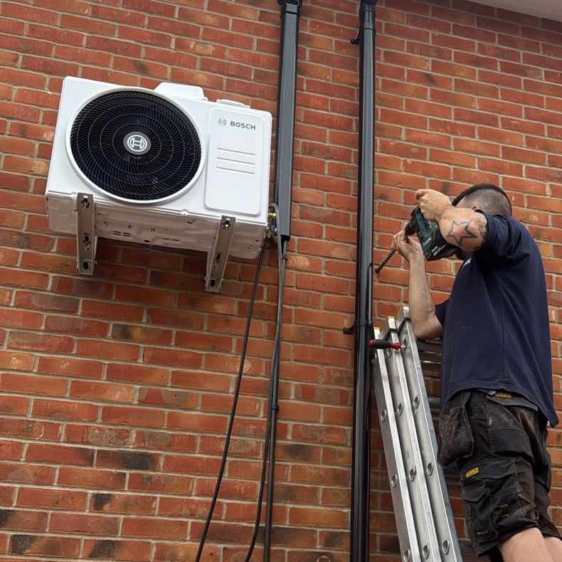 A technician repairing an outdoor air conditioner
