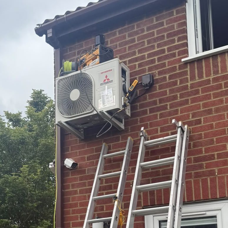 Two ladders against house being used for air conditioning maintenance