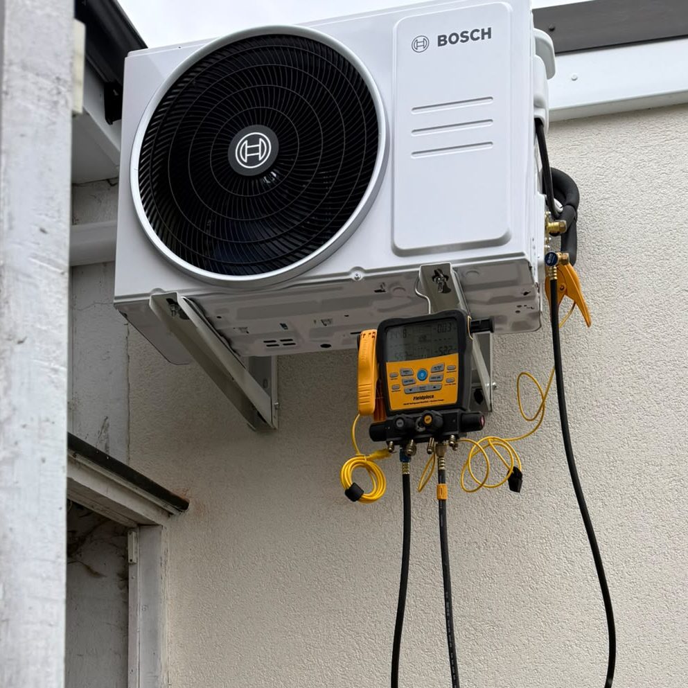 Step ladder and tools next to air conditioning unit